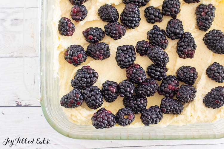 batter in baking dish topped with blackberries