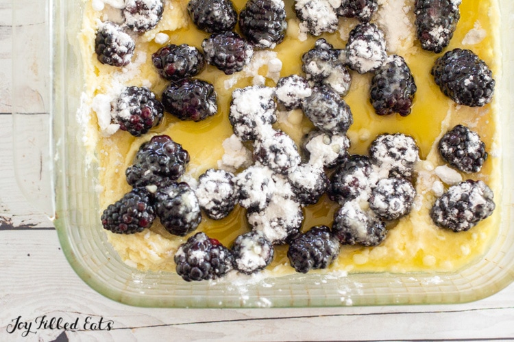 batter in baking dish topped with blackberries