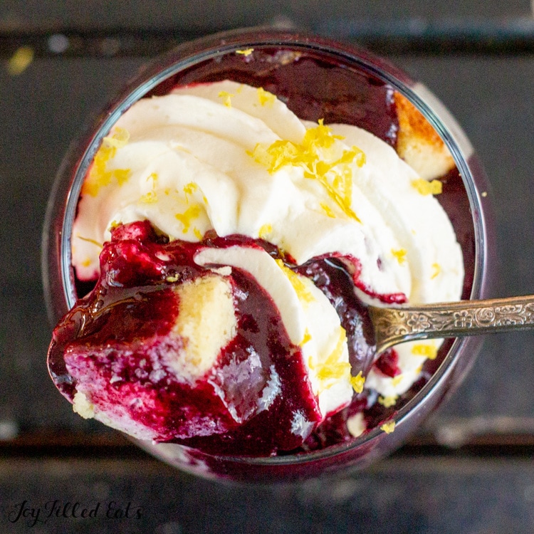 bite of trifle with keto blueberry sauce on a spoon