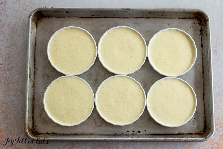 creme brulee dishes on a baking sheet