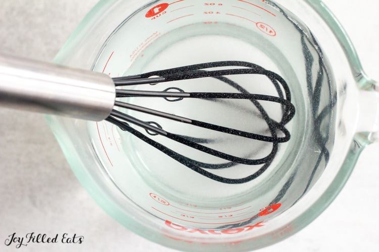 whisk in a measuring cup of keto simple syrup