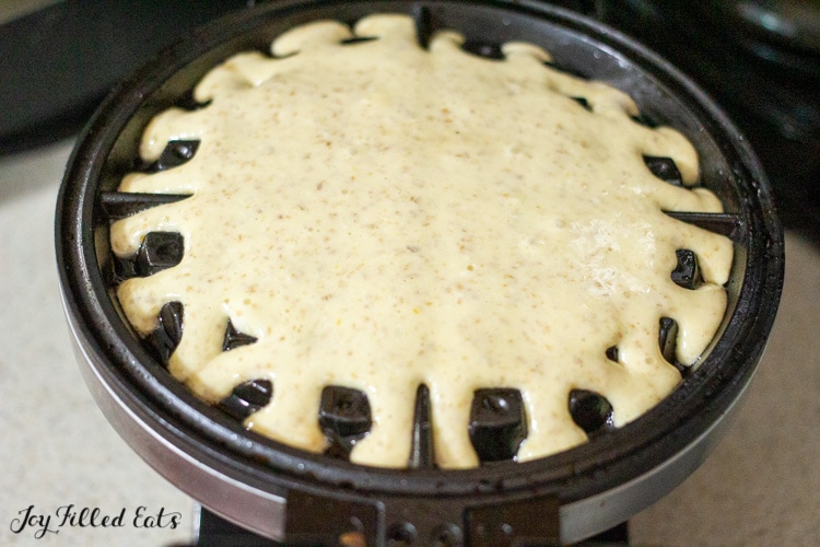batter in a waffle maker close up