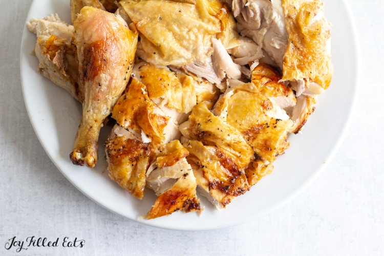 air fryer whole chicken cut up on a plate