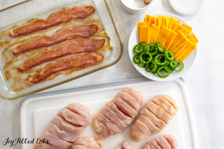 sliced chicken breasts on cutting board