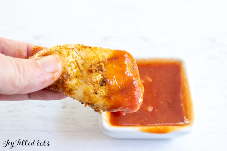 piece of chicken dipped in low carb barbecue sauce