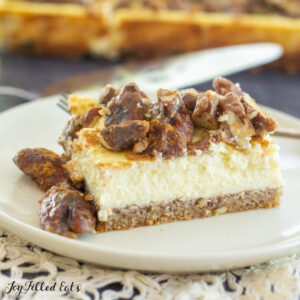 close up of a butter pecan cheesecake bar on a plate