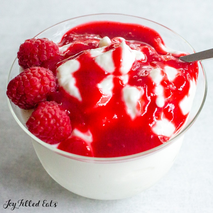 close up of keto raspberry sauce on top of yogurt
