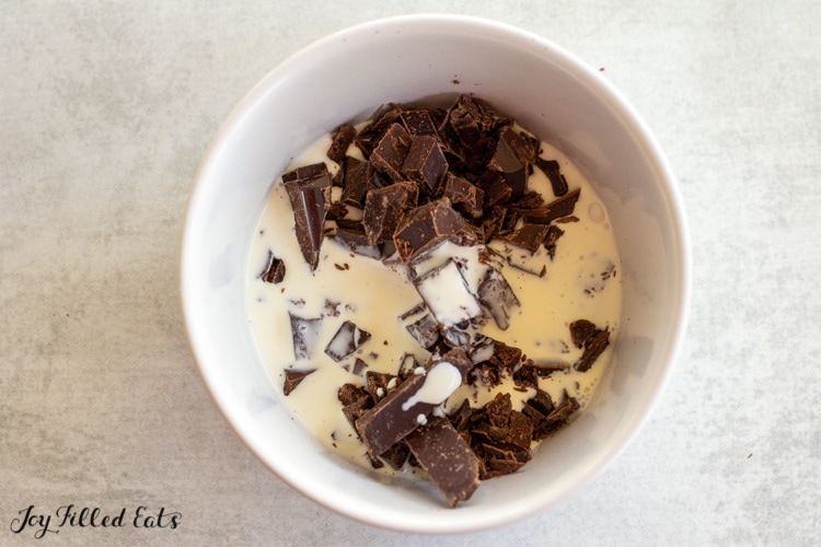 chopped chocolate and cream in a bowl