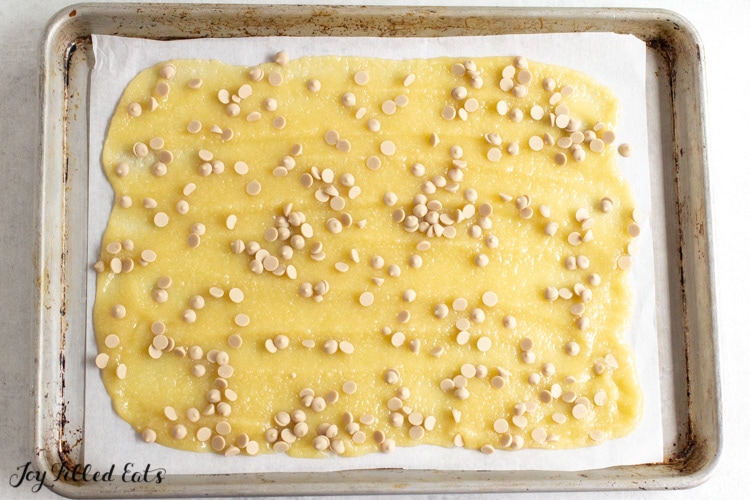 batter spread thin on parchment paper lined pan