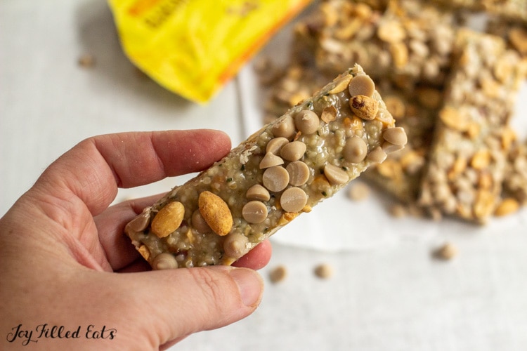 hand holding on of the keto peanut butter bars