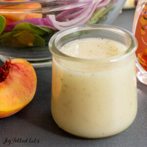 close up of a jar of peach vinaigrette