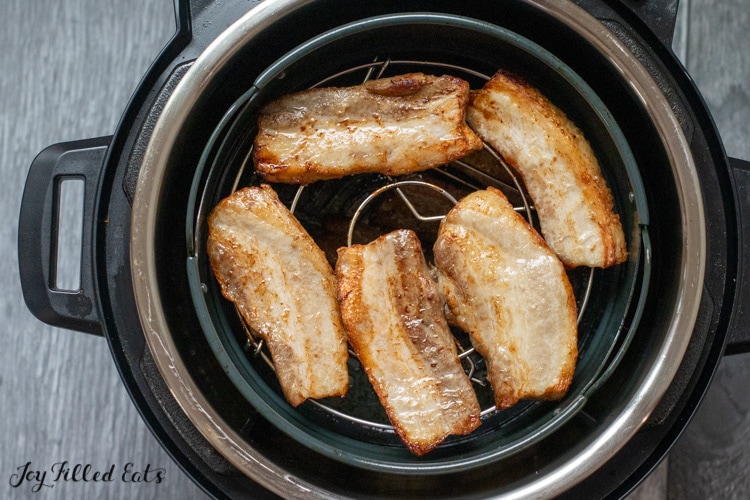 partially cooked meat in basket