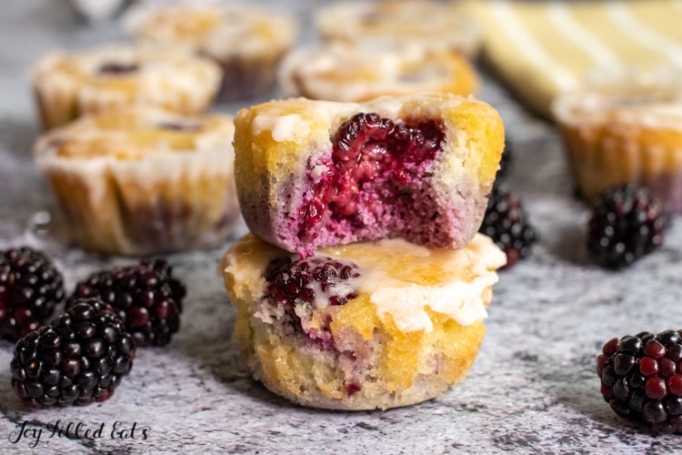 two almond flour blackberry muffins stacked on top of each other