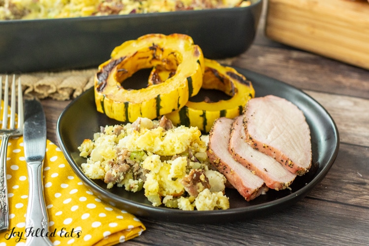 plate of sliced smoked pork loin with keto sausage stuffing and air fryer delicata squash