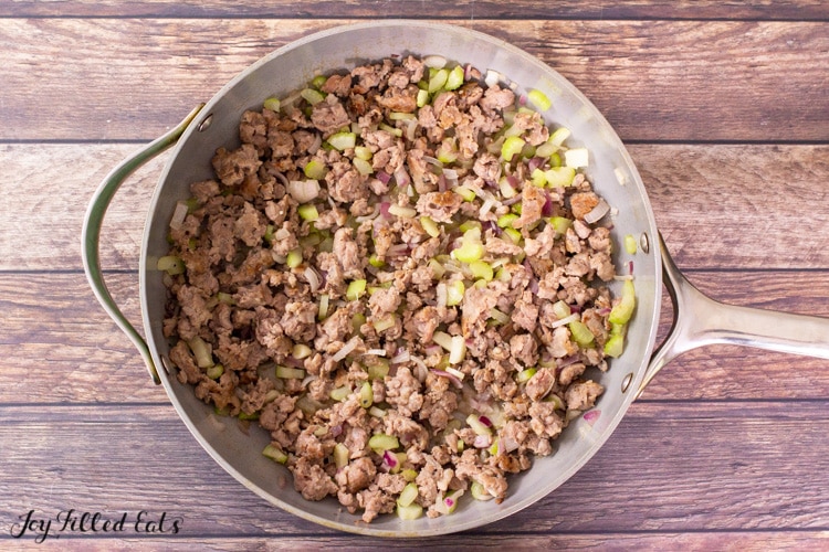 skillet with browned sausage celery and shallots