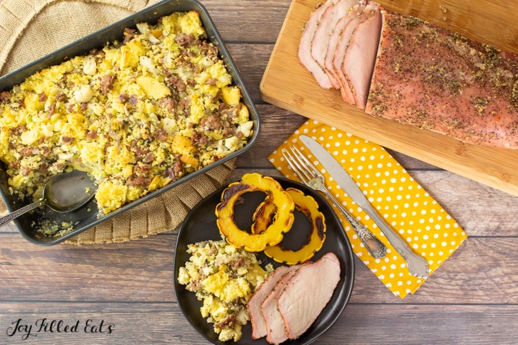 plate of sliced smoked pork loin with keto sausage stuffing and air fryer delicata squash