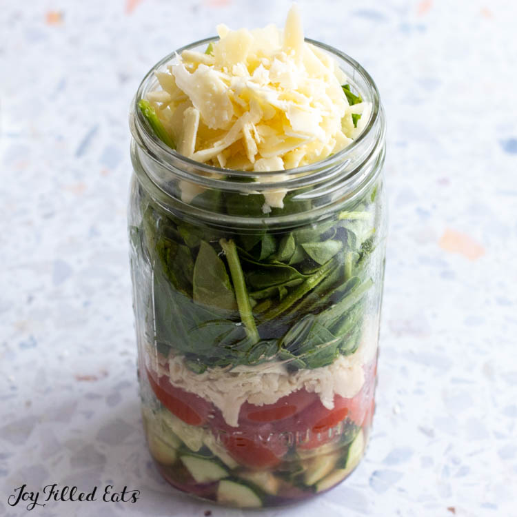cheese on top of salad in jar