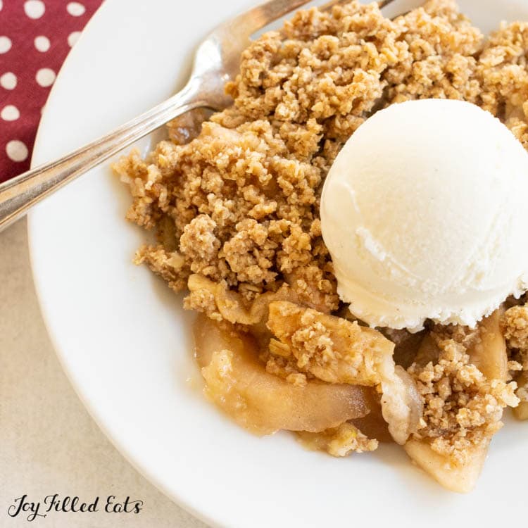 close up of sugar free apple crisp on plate with keto vanilla ice cream