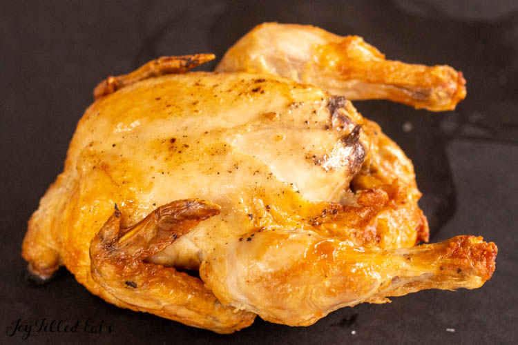 cooked air fryer cornish hen on cutting board