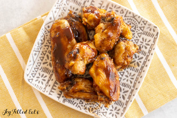 overhead shot of wings with bbq sauce on a plate