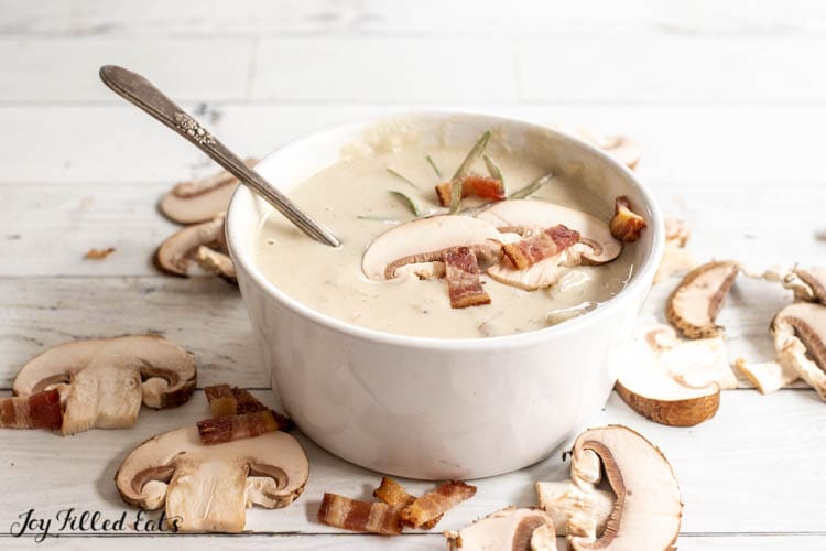 bowl of mushroom soup topped with bacon