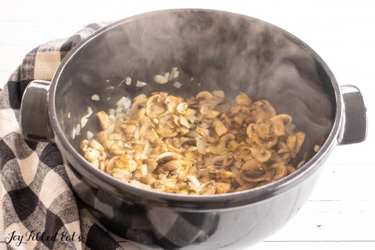 steaming pot of sauteed mushrooms