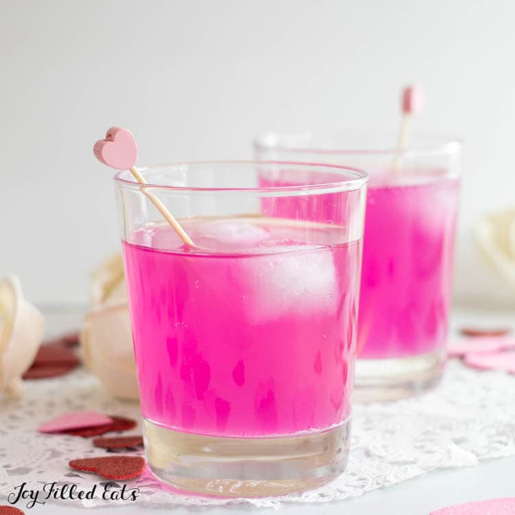 two rocks glasses with pink lemonade vodka punch