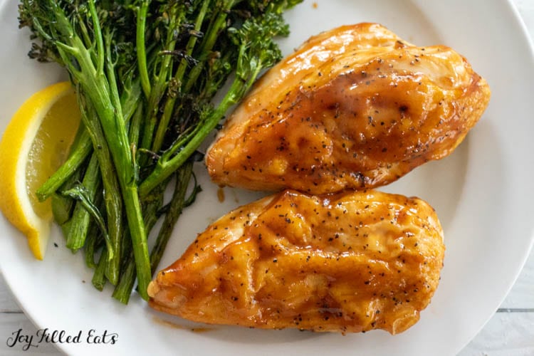 chicken breasts with barbecue sauce served with broccolini