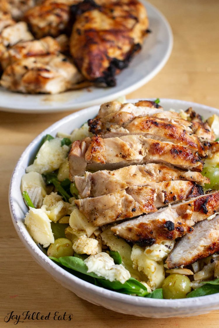 grilled chicken with keto chicken marinade sliced and served on salad
