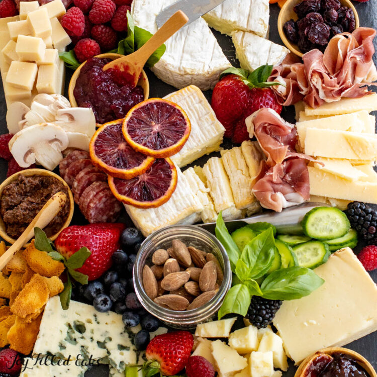 close up of items on keto charcuterie board: assorted cheeses, meats, and berries
