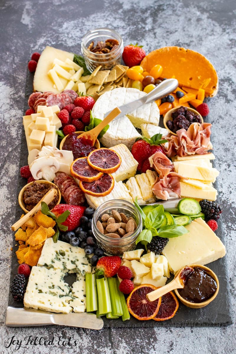 full view of the keto charcuterie board with berries, herbs, and keto crackers