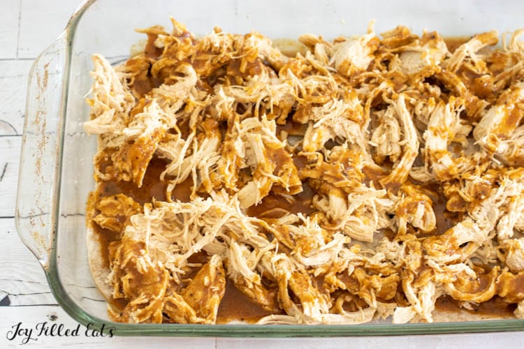 shredded chicken with sauce in pyrex dish