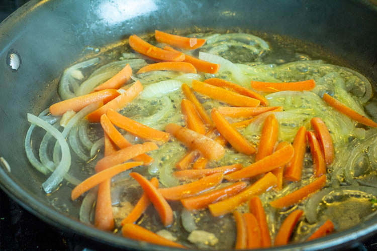 onions and carrots in skillet