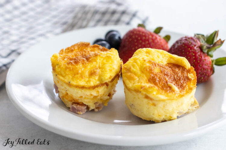 white plate with omelet bites and strawberries