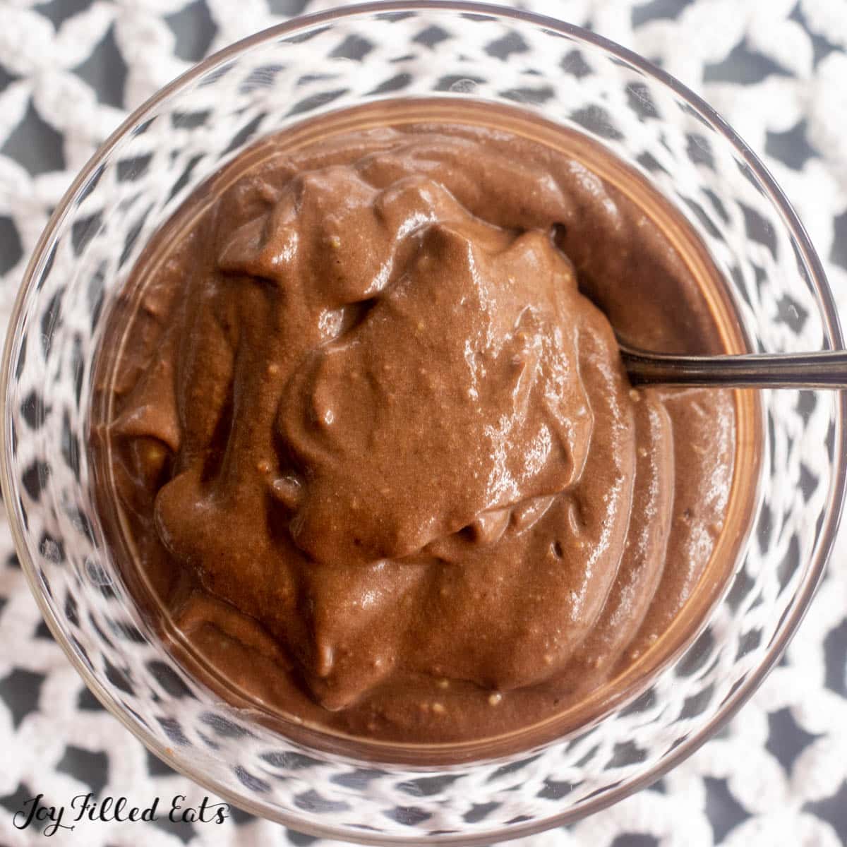 spoon in keto avocado chocolate pudding close up
