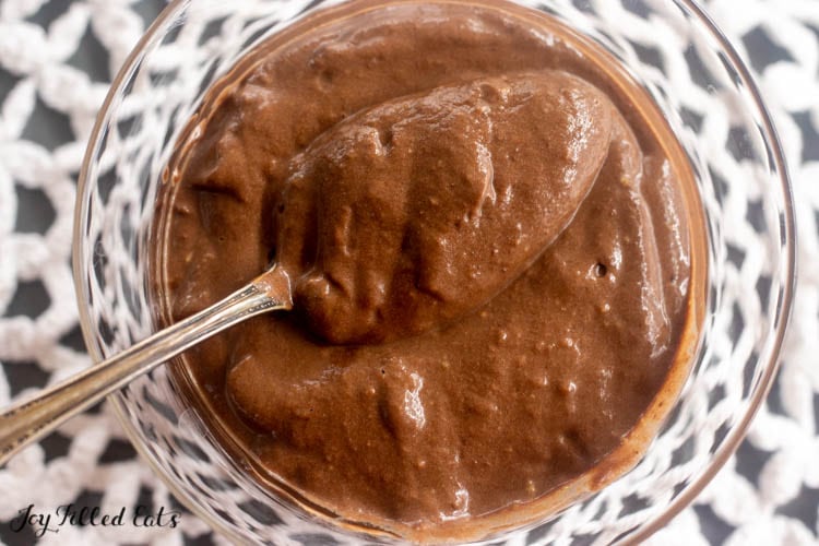 spoon in keto avocado chocolate pudding showing texture