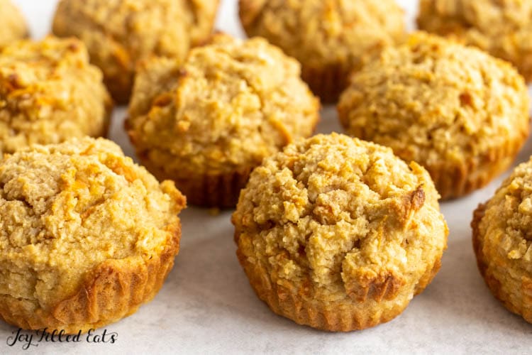 keto carrot cake muffins on a white surface