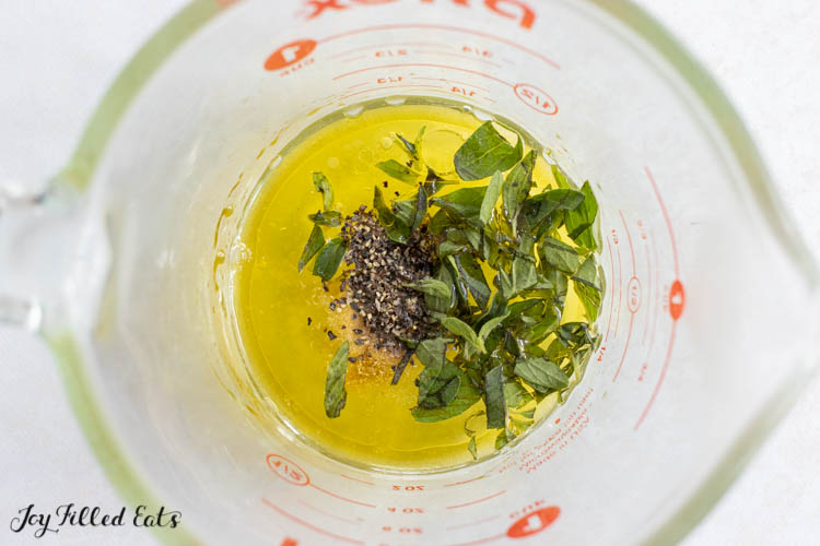 olive oil, lemon juice, and seasonings in measuring cup