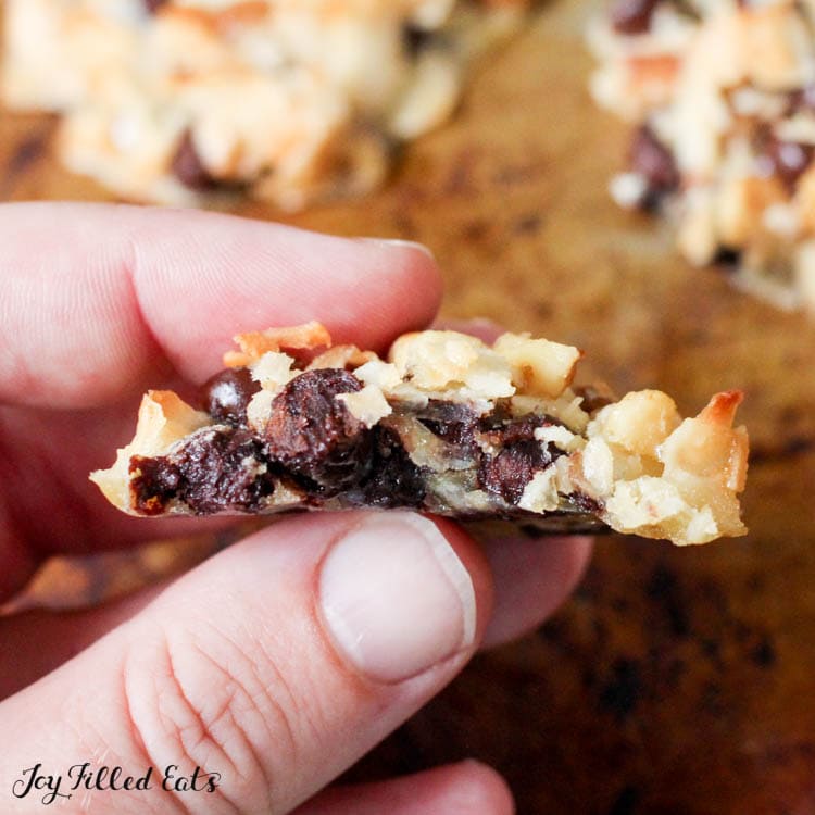 hand holding one of the keto magic cookies with a bite missing