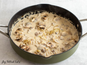 large skillet of ground lamb, onions, and mushrooms in creamy sauce