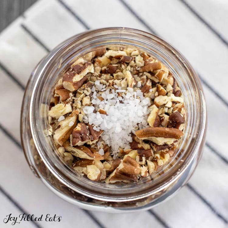 jar with pecans and coarse salt near the top