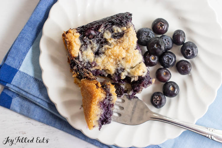 keto blueberry pie bars on a plate with bite on a fork