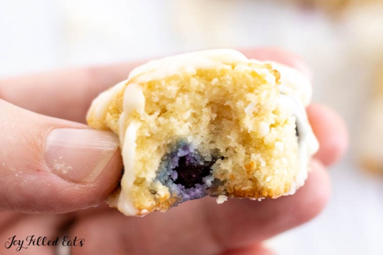 hand holding one of the keto blueberry scones with bite missing