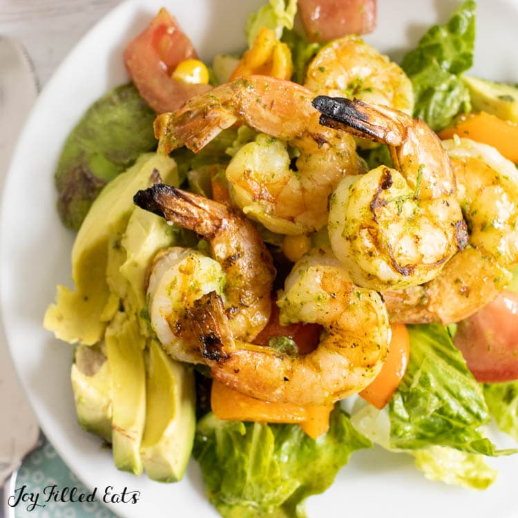 close up of mexican avocado salad with grilled shrimp