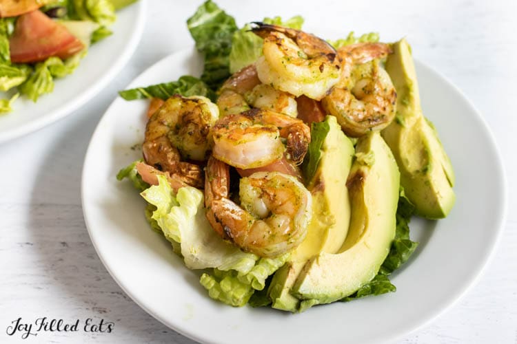 close up of mexican avocado salad with grilled shrimp