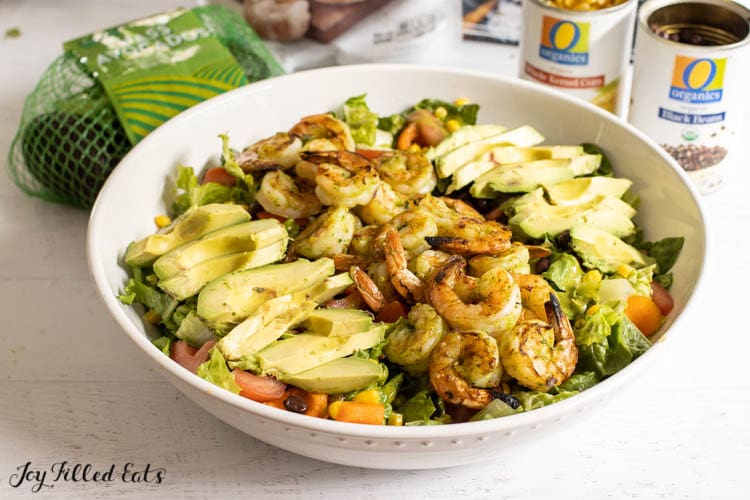 mexican avocado salad with grilled shrimp in large bowl