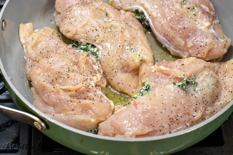 spinach and ricotta stuffed chicken breasts in skillet
