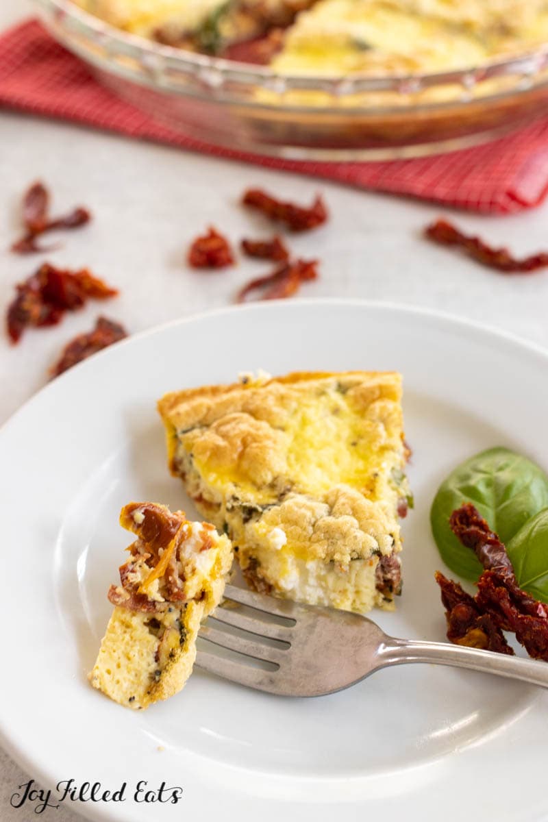 close up of bite of sundried tomato quiche on a fork