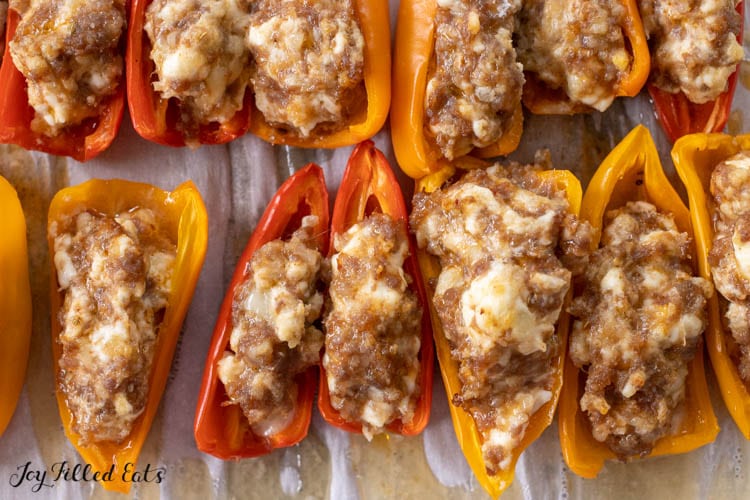 baked mini Stuffed Peppers with Cream Cheese and Sausage on parchment paper lined tray