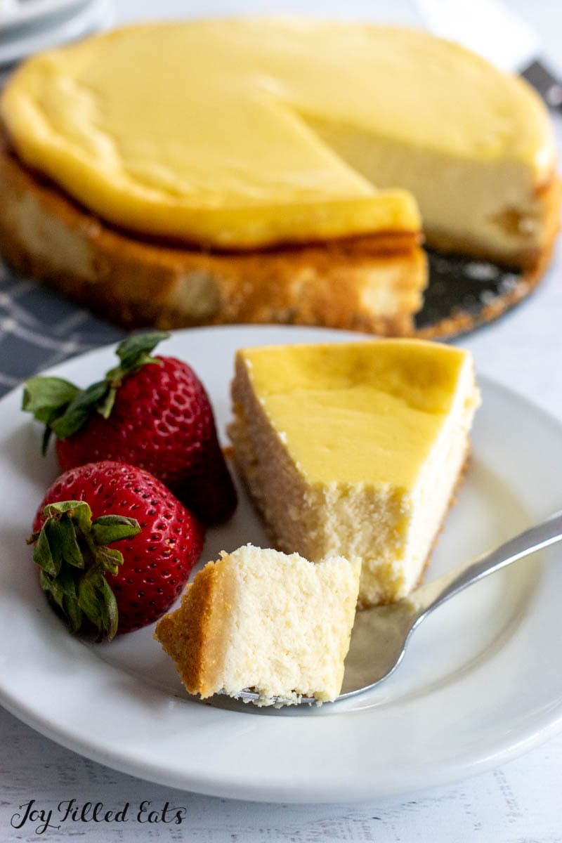 slice of protein cheesecake on plate with remaining cheesecake behind